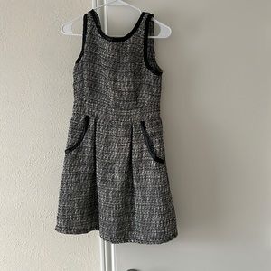 Woven black and white dress with leather accents.